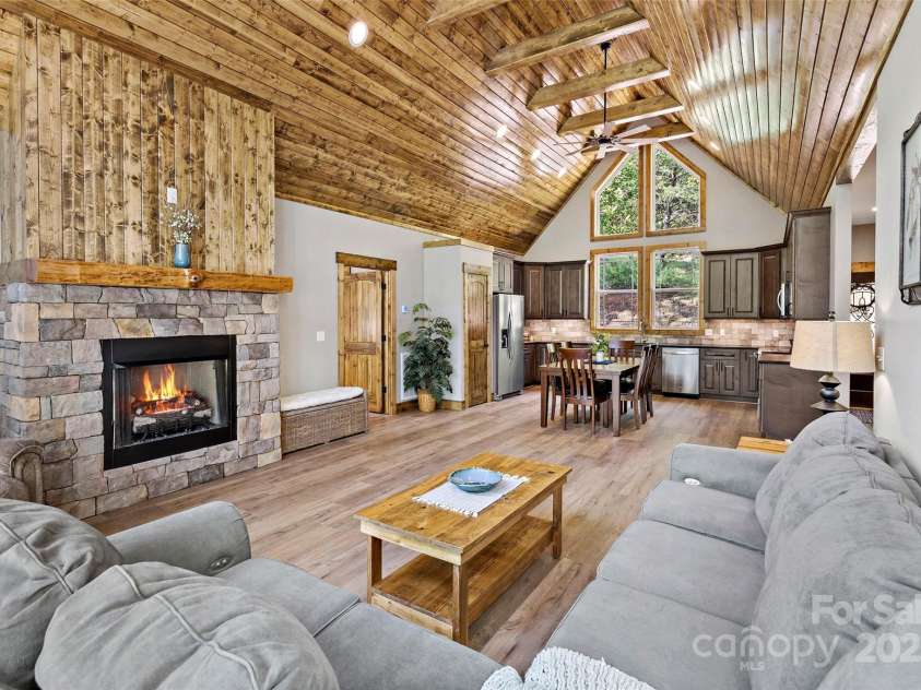 23 Laurel Crest Lane, Mill Spring, NC 28756.  MLS# CAR4294698, YatesRealty ID 34956. Open living room and kitchen areas