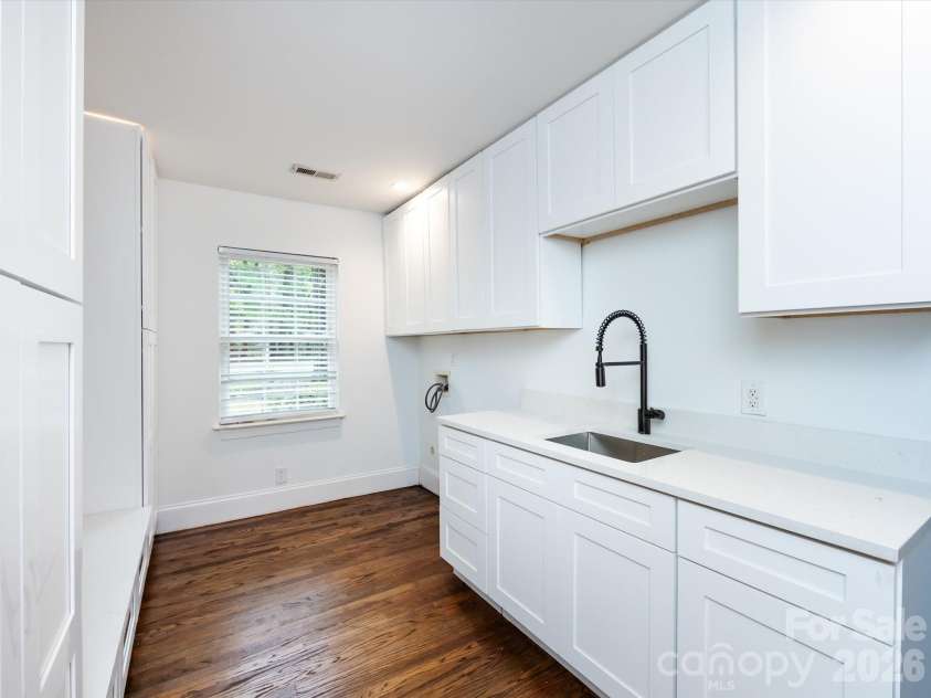 3109 Forest Lawn Drive, Matthews, NC 28104.  MLS# CAR4353965, YatesRealty ID 3497. Laundry with storage / sink