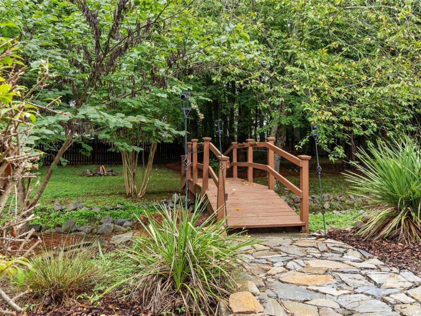 3121 Spring Fancy Lane, Indian Trail, NC 28079.  MLS# CAR4289656, YatesRealty ID 34973. Picturesque bridge over creek in your back yard