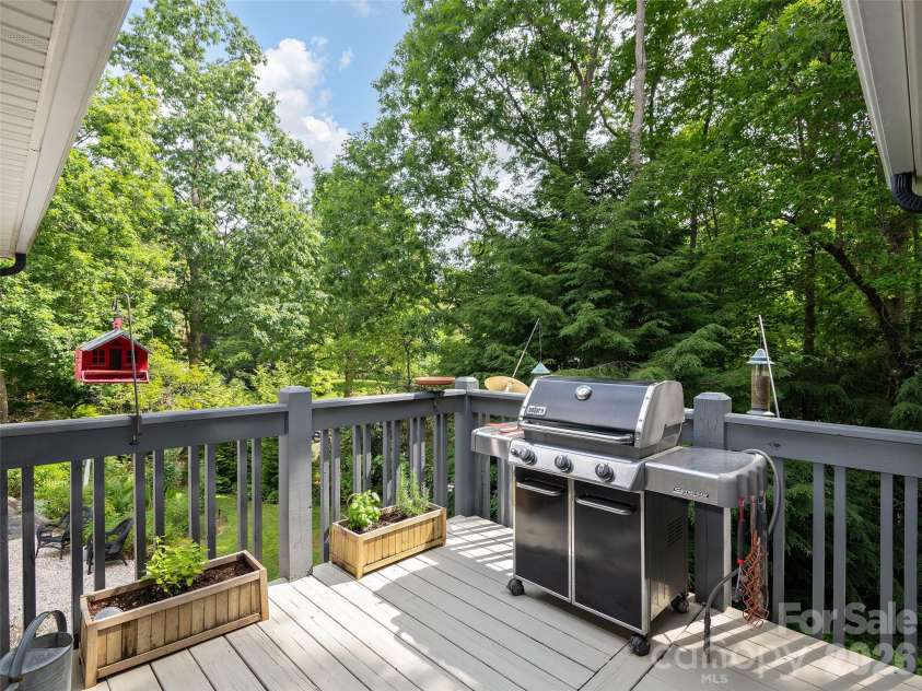 122 Brandon Road, Hendersonville, NC 28739.  MLS# CAR4391483, YatesRealty ID 34975. Convenient grilling deck with elevated views of the private backyard