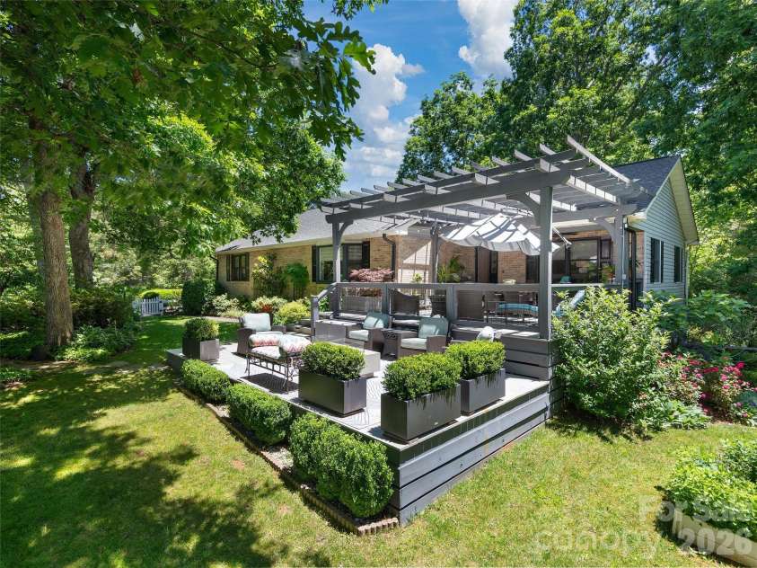 122 Brandon Road, Hendersonville, NC 28739.  MLS# CAR4391483, YatesRealty ID 34975. Expansive outdoor entertaining space featuring a custom designed pergola and  large open deck with firepit