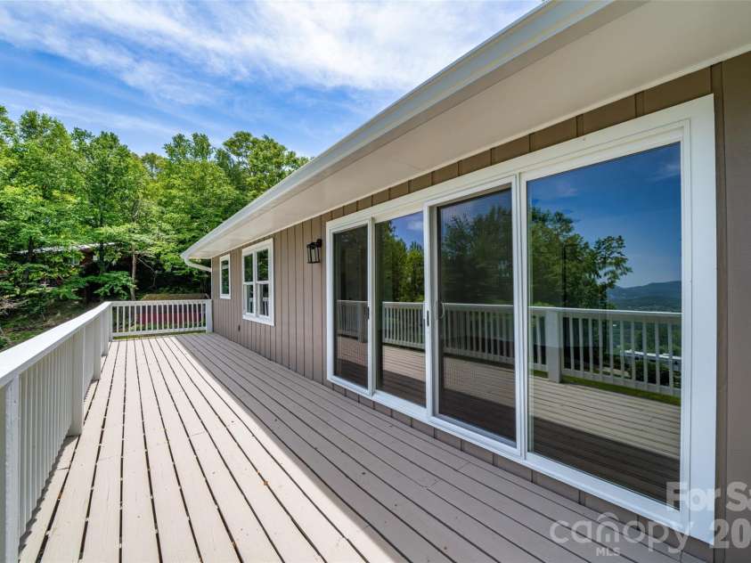 69 Milburn Lane, Hendersonville, NC 28792.  MLS# CAR4383006, YatesRealty ID 34983. Spacious deck with easy access to interior spaces