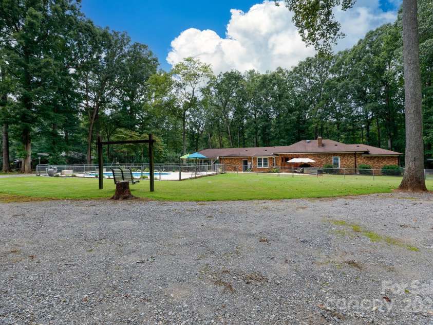 4520 Belhaven Forest Drive, Gastonia, NC 28056.  MLS# CAR4294728, YatesRealty ID 34993. Double gravel driveway plus.  2 seater swing to stay.