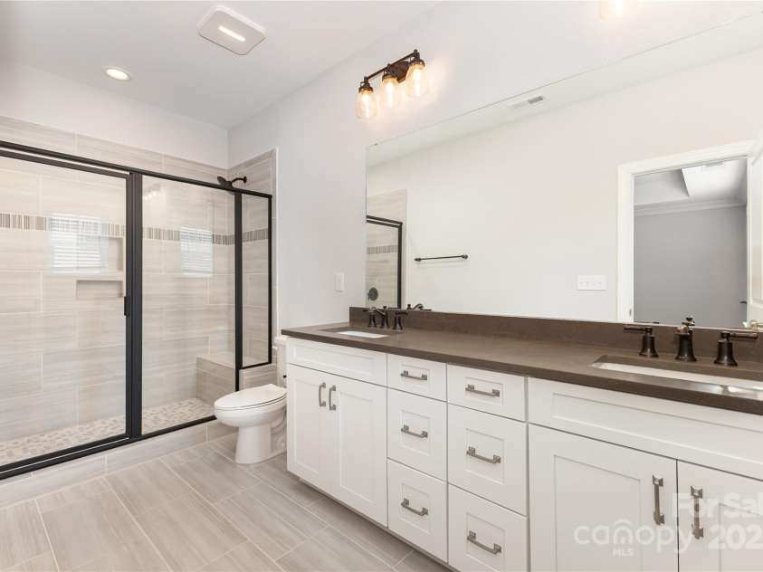 12313 Landry Renee Place, Charlotte, NC 28277.  MLS# CAR4294367, YatesRealty ID 35001. Owners suite Bath, dual vanity tile shower