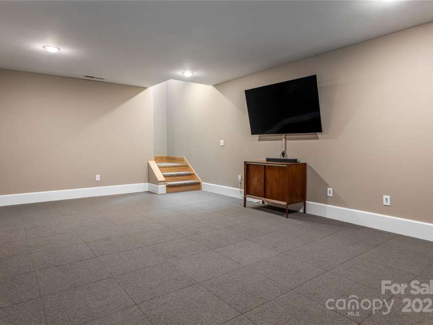 7 Bee Balm Way, Asheville, NC 28804.  MLS# CAR4290500, YatesRealty ID 35016. Bonus room in basement with removable carpet (finished concrete under carpet squares)