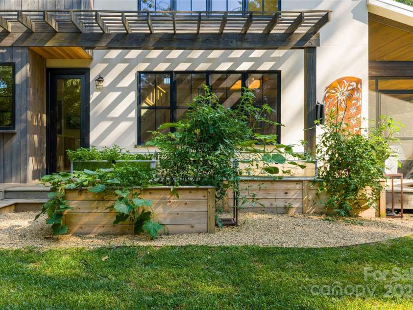 7 Bee Balm Way, Asheville, NC 28804.  MLS# CAR4290500, YatesRealty ID 35016. Raised beds for gardening and cedar hot tub for relaxing