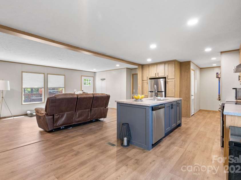 102 Kiwassa Lane, Hendersonville, NC 28792.  MLS# CAR4333333, YatesRealty ID 35028. Large kitchen island looking into the living room