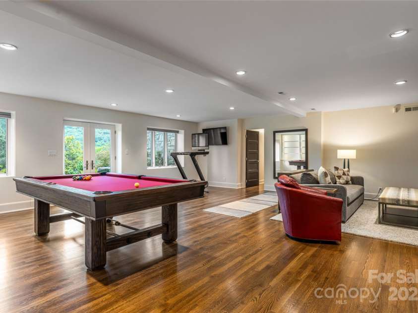 80 Kimberly Knoll Road, Asheville, NC 28804.  MLS# CAR4275443, YatesRealty ID 35034. Room for recreation, media-viewing and working out in the walk-out basement.