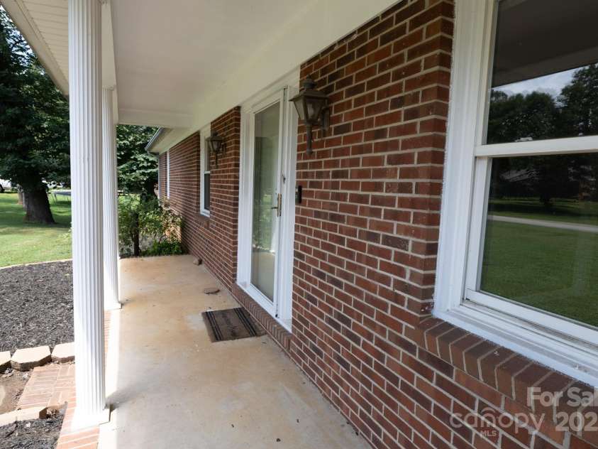 205 Dana Drive, Salisbury, NC 28147.  MLS# CAR4288780, YatesRealty ID 35059. Rocking chair front porch