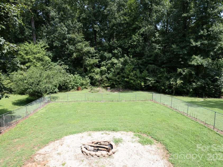 205 Dana Drive, Salisbury, NC 28147.  MLS# CAR4288780, YatesRealty ID 35059. View from covered deck overlooking fenced backyard and fire pit area