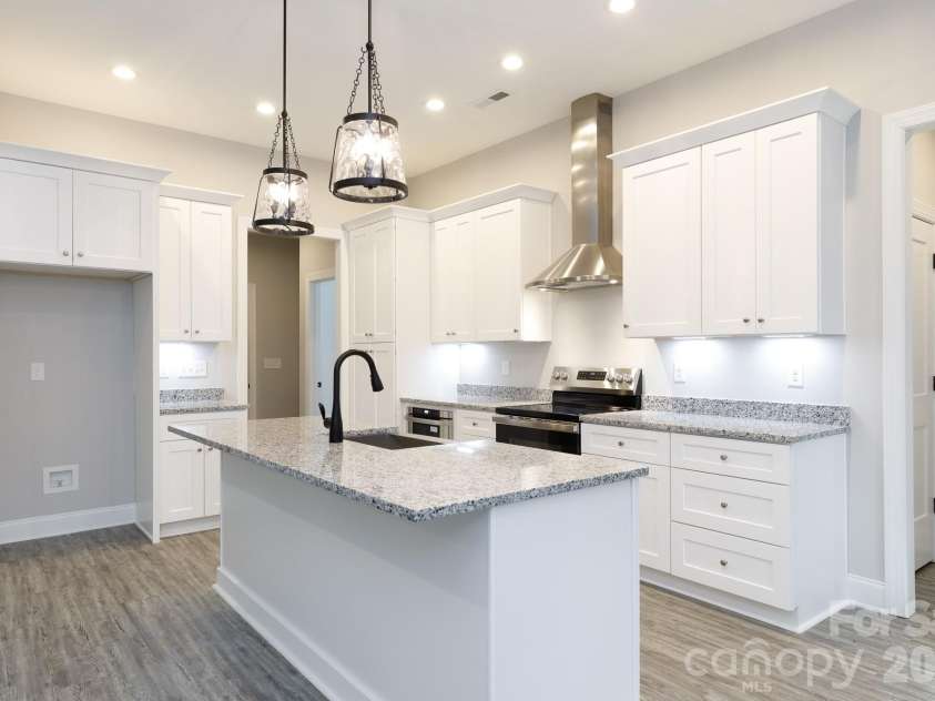 502 Squaw Lane, Edgemoor, SC 29712.  MLS# CAR4342690, YatesRealty ID 3506. Hall to the laundry and 1/2 bath along with a hall to the primary bedroom are  located off the kitchen.