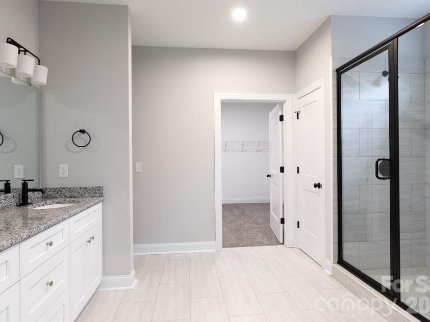 502 Squaw Lane, Edgemoor, SC 29712.  MLS# CAR4342690, YatesRealty ID 3506. Main bath with tile floors, walk-in tiled shower and double sink.