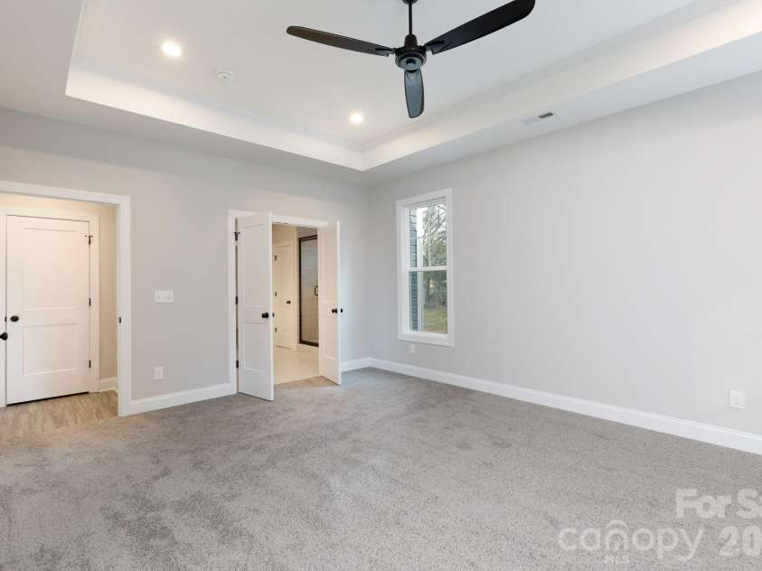 502 Squaw Lane, Edgemoor, SC 29712.  MLS# CAR4342690, YatesRealty ID 3506. Primary bedroom with carpet and tray ceiling.