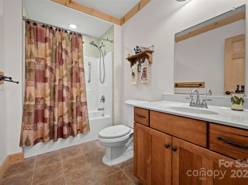 23 Jay Foster Way, Saluda, NC 28773.  MLS# CAR4323305, YatesRealty ID 35063. Bath 2 has tile floor  and tub/shower with Ceramic Tile trim, ceramic tile floor, as well as wrought  iron accessories throughout!