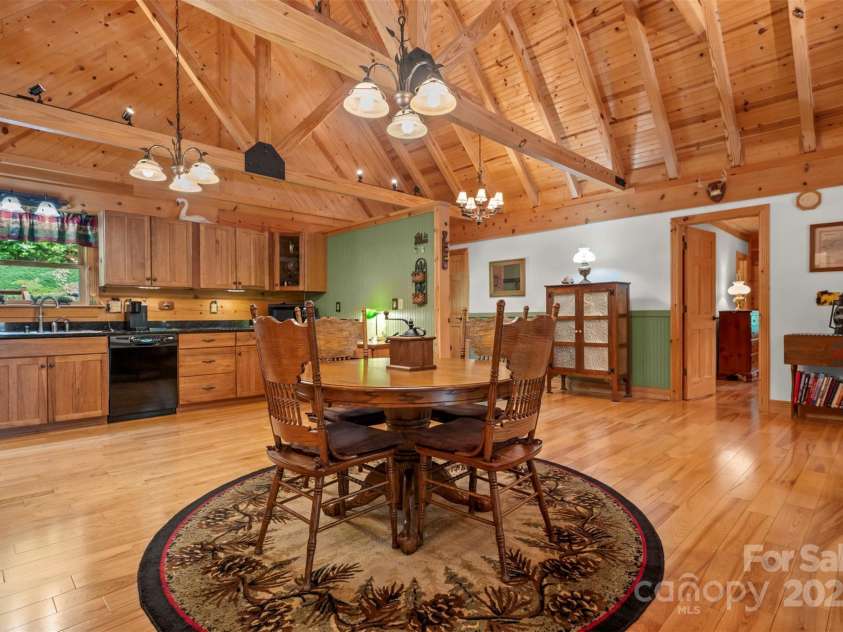 23 Jay Foster Way, Saluda, NC 28773.  MLS# CAR4323305, YatesRealty ID 35063. View of Dining/Kitchen with primary bedroom entry to the right of photo.
