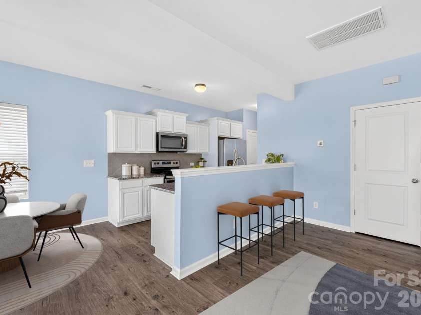 12551 Gotland Road, Midland, NC 28107.  MLS# CAR4396303, YatesRealty ID 35069. Open Kitchen with Breakfast Bar & Dining Area - Virtually Staged