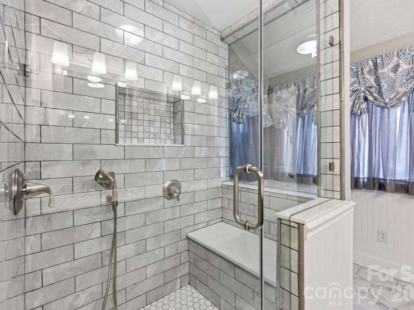 3970 Tenneyson Court, Concord, NC 28027.  MLS# CAR4398947, YatesRealty ID 35089. Beautiful walk-in tile shower with sitting bench