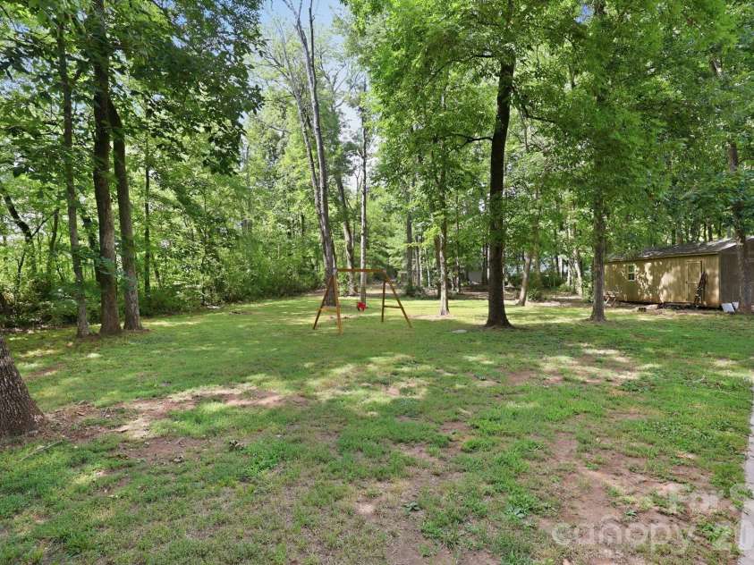 3970 Tenneyson Court, Concord, NC 28027.  MLS# CAR4398947, YatesRealty ID 35089. Spacious backyard surrounded by mature trees
