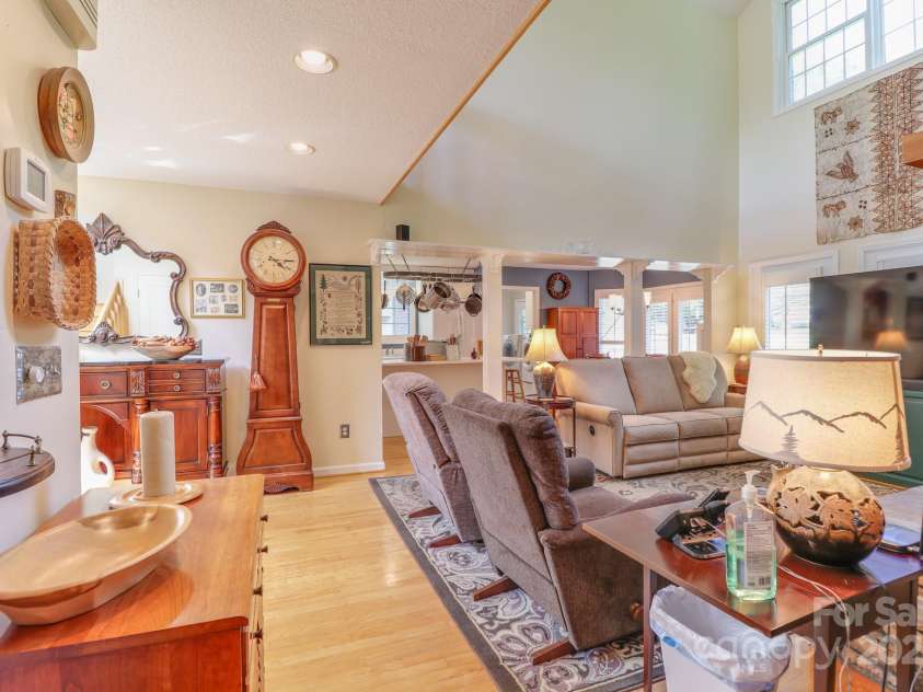 51 Windy Acres Drive, Fairview, NC 28730.  MLS# CAR4297537, YatesRealty ID 35098. Living room towards kitchen