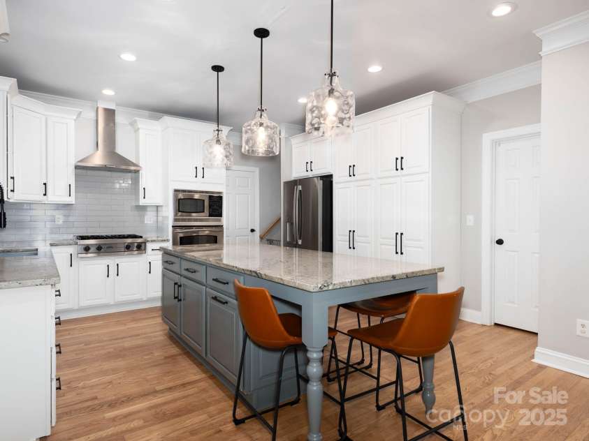 19112 Glouster Court, Cornelius, NC 28031.  MLS# CAR4291361, YatesRealty ID 35099. Abundant storage and walk in pantry.  Stainless hood and gas cooktop