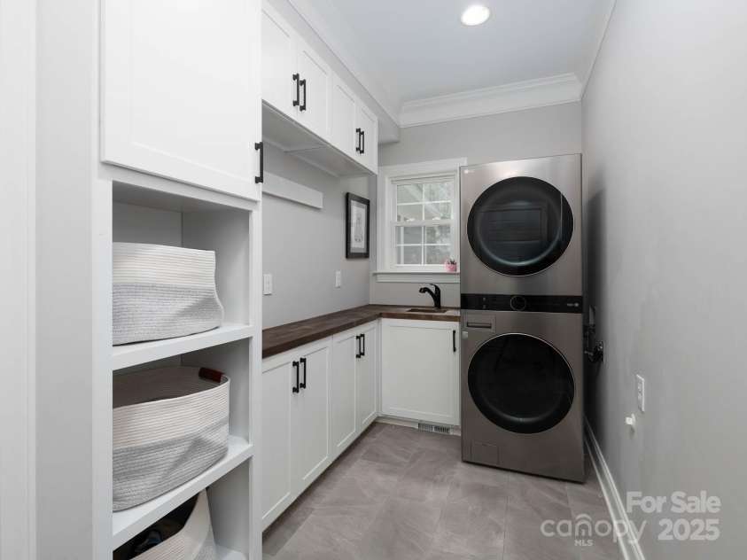 19112 Glouster Court, Cornelius, NC 28031.  MLS# CAR4291361, YatesRealty ID 35099. Sink and custom cabinets make for a tidy, functional laundry room!!