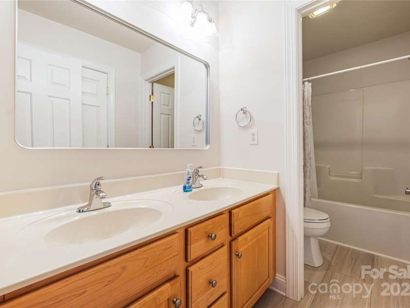 9603 Devonshire Drive, Huntersville, NC 28078.  MLS# CAR4292851, YatesRealty ID 35141. Full bathroom that supports the upstairs bathrooms.  Double sink and new LVP flooring.