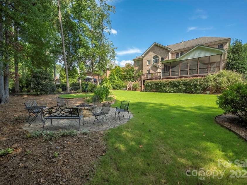 9603 Devonshire Drive, Huntersville, NC 28078.  MLS# CAR4292851, YatesRealty ID 35141. The level backyard offers a spot to enjoy cool evenings with a stonework firepit.