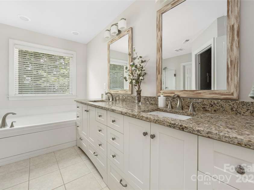 9603 Devonshire Drive, Huntersville, NC 28078.  MLS# CAR4292851, YatesRealty ID 35141. Updated primary bathroom with new height vanity,  seamless glass shower and separate tub.