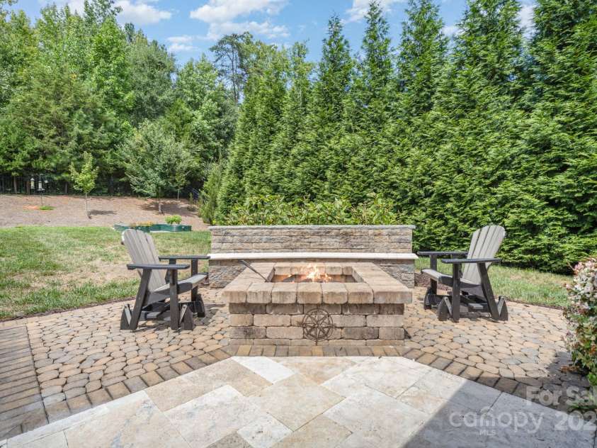 6211 Jepson Court, Charlotte, NC 28214.  MLS# CAR4293083, YatesRealty ID 35158. Built in fire pit with custom stone bench.