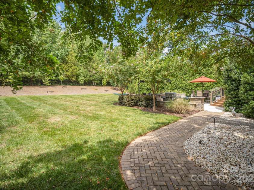6211 Jepson Court, Charlotte, NC 28214.  MLS# CAR4293083, YatesRealty ID 35158. Paver walkway to the driveway from the backyard.