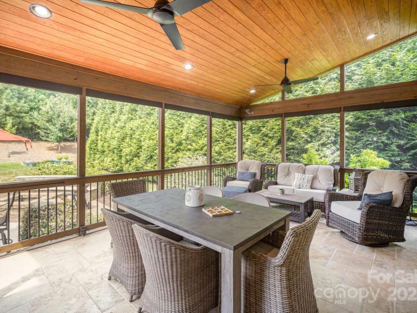 6211 Jepson Court, Charlotte, NC 28214.  MLS# CAR4293083, YatesRealty ID 35158. Screen in porch showing the view of the privacy screen trees in the backyard.