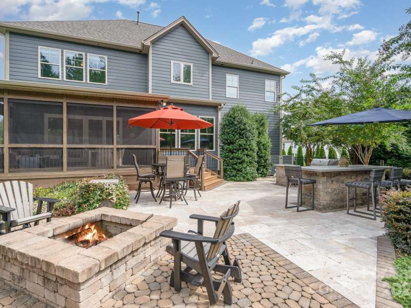 6211 Jepson Court, Charlotte, NC 28214.  MLS# CAR4293083, YatesRealty ID 35158. View of the back of the home with firepit and built in bar top.