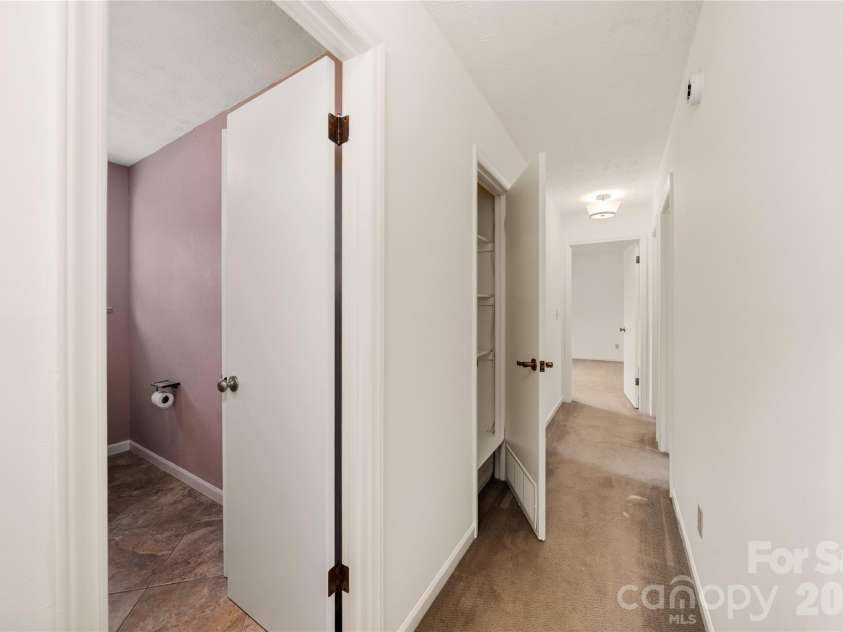 8 Wedgewood Drive, Mills River, NC 28759.  MLS# CAR4398096, YatesRealty ID 35159. Long upper hallway with another large flex storage closet