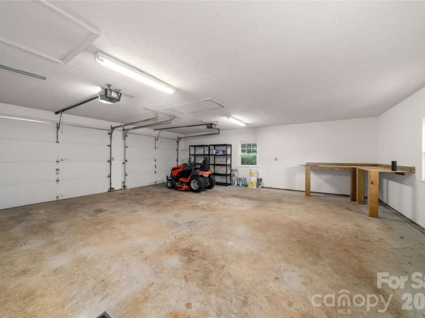 8 Wedgewood Drive, Mills River, NC 28759.  MLS# CAR4398096, YatesRealty ID 35159. Oversized 2 car garage with 2 windows for ventilation, built in custom workbench and room to backyard