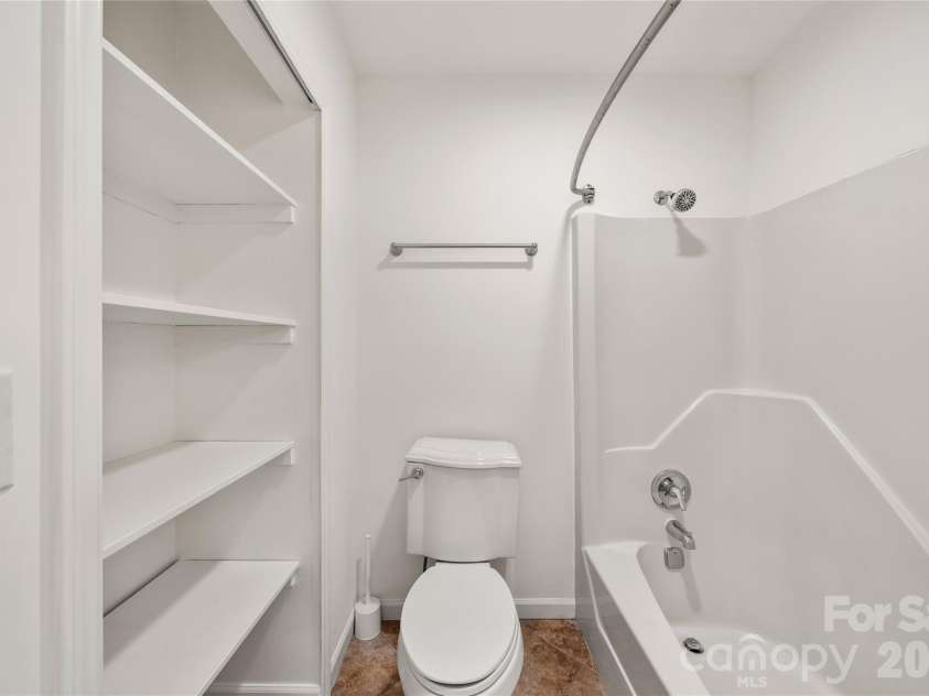 8 Wedgewood Drive, Mills River, NC 28759.  MLS# CAR4398096, YatesRealty ID 35159. Primary bath with extra linen and towel storage and separate commmode and shower area