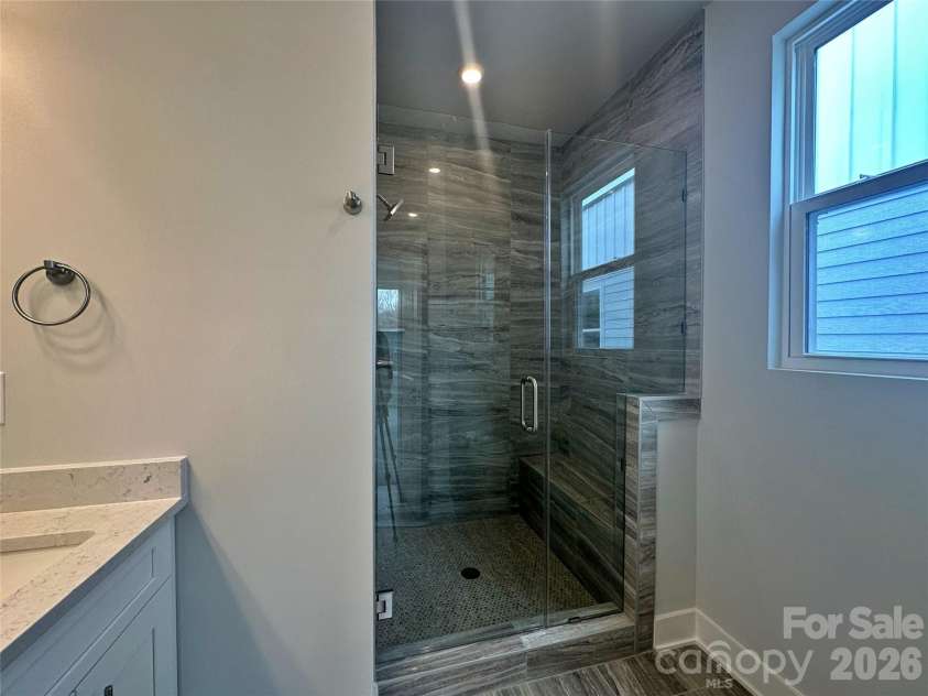 2035 Clarksdale Drive, Charlotte, NC 28206.  MLS# CAR4227622, YatesRealty ID 35165. Frameless Glass Door and Ceiling Height Tile in the Owner's Shower