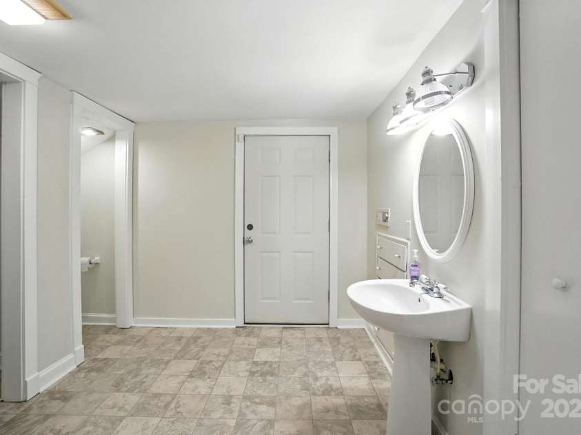 502 Elm Street, Marshville, NC 28103.  MLS# CAR4285320, YatesRealty ID 35172. Half bath upstairs has space for a free standing tub, and the bathroom was plumbed for it. But to install a tub you'll need to take up the flooring to access.