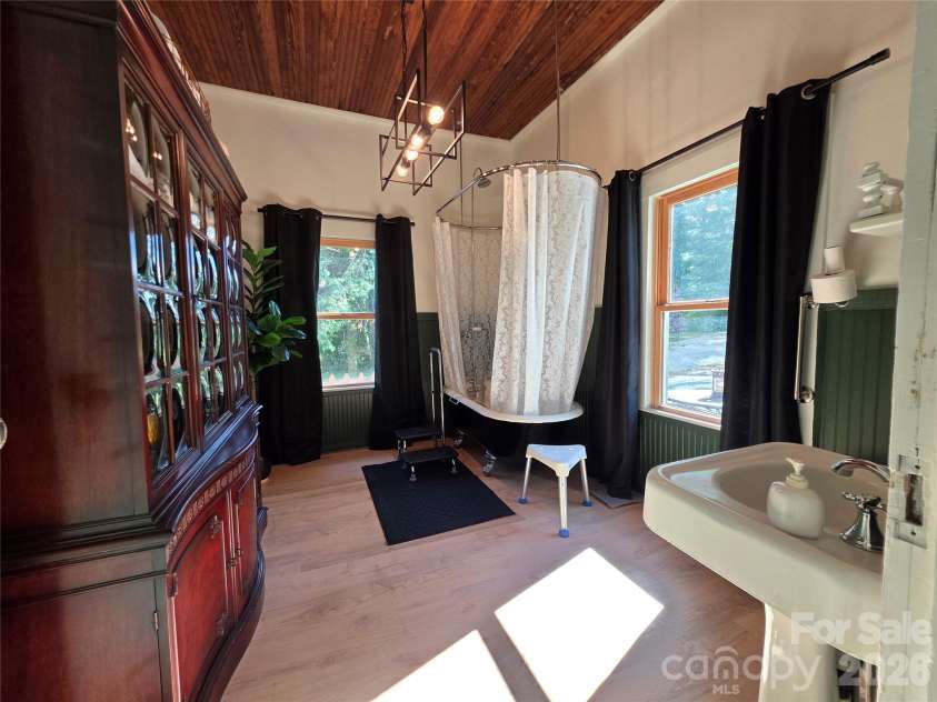 38 Lloyd Barnwell Road, Hendersonville, NC 28792.  MLS# CAR4394211, YatesRealty ID 35210. Large bathroom with laundry in a closet.