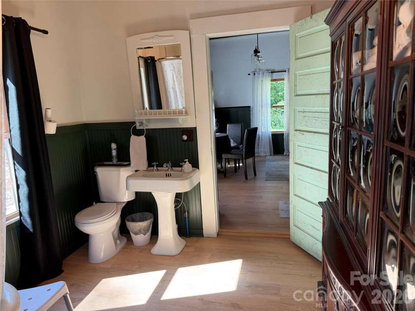 38 Lloyd Barnwell Road, Hendersonville, NC 28792.  MLS# CAR4394211, YatesRealty ID 35210. Large bathroom with laundry in the closet.