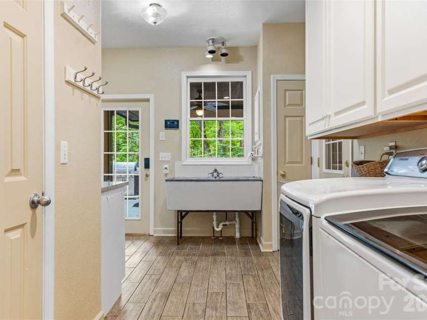 61 Scroops Drive, Swannanoa, NC 28778.  MLS# CAR4393585, YatesRealty ID 35237. Laundry room off the primary bathroom.