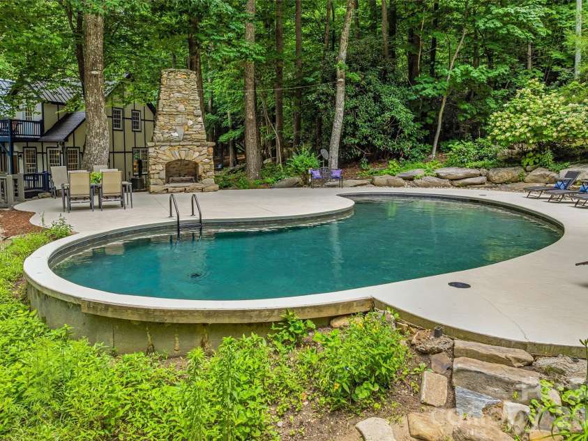 61 Scroops Drive, Swannanoa, NC 28778.  MLS# CAR4393585, YatesRealty ID 35237. Stone fireplace from previous home, heated, saltwater pool