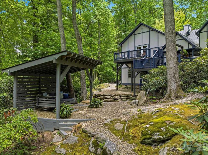 61 Scroops Drive, Swannanoa, NC 28778.  MLS# CAR4393585, YatesRealty ID 35237. Swinging covered bed by the creek.