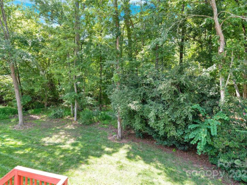 11201 Tavernay Parkway, Charlotte, NC 28262.  MLS# CAR4277991, YatesRealty ID 35248. Back yard trees