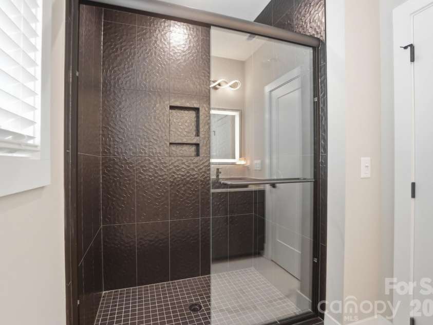 5225 Glenwalk Drive, Charlotte, NC 28269.  MLS# CAR4381104, YatesRealty ID 35264. Floor to ceiling tile shower