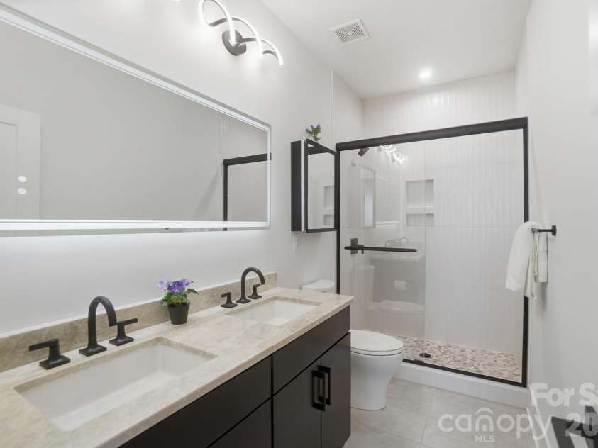 5225 Glenwalk Drive, Charlotte, NC 28269.  MLS# CAR4381104, YatesRealty ID 35264. Full bath with dual vanities and large LED mirror