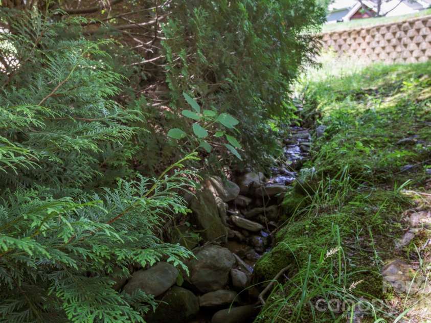 15 Kaylor Drive, Arden, NC 28704.  MLS# CAR4388754, YatesRealty ID 35268. Small Stream in Backyard