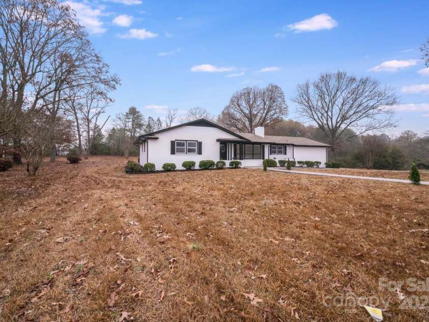 111 Oakmont Road, Stanley, NC 28164.  MLS# CAR4213473, YatesRealty ID 3528. View of long set back from the road.
