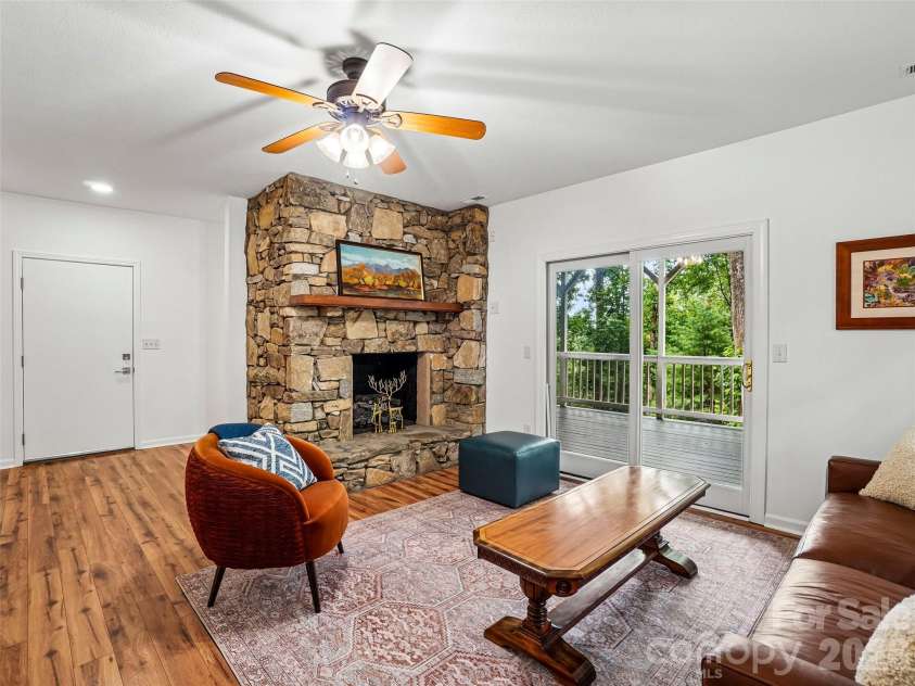 10 Chestnut Top Circle, Mills River, NC 28759.  MLS# CAR4392677, YatesRealty ID 35280. Den with stone fireplace