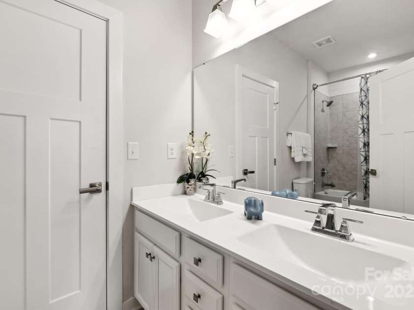 5112 Larewood Drive, Harrisburg, NC 28215.  MLS# CAR4297584, YatesRealty ID 35281. Main Level Guest Bathroom with Dual Vanities