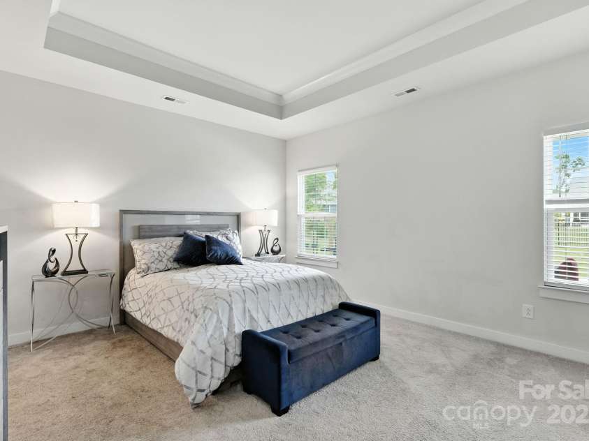 5112 Larewood Drive, Harrisburg, NC 28215.  MLS# CAR4297584, YatesRealty ID 35281. Main Level Primary Bedroom with tray ceiling.
